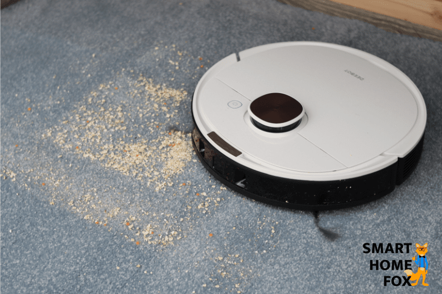 Ecovacs Deebot OZMO T8+ vacuums oatmeal on a carpet